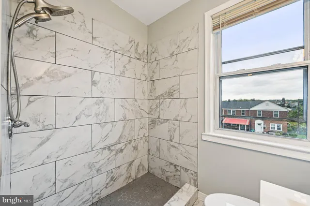 a bathroom with a toilet and a shower