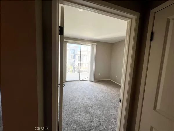 a view of an empty room and a window