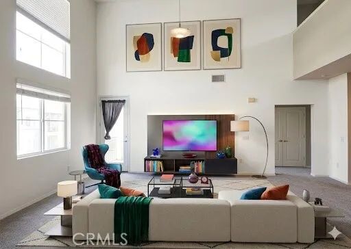 a living room with furniture a window and a flat screen tv