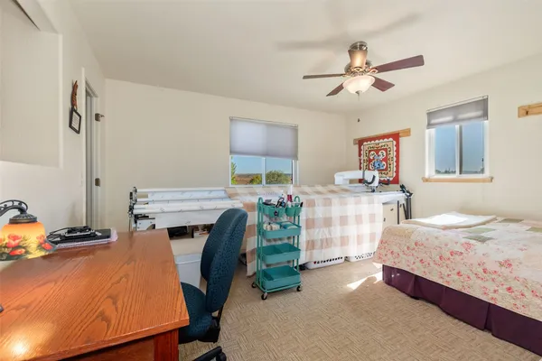 a bed room with a bed mirror and a desk