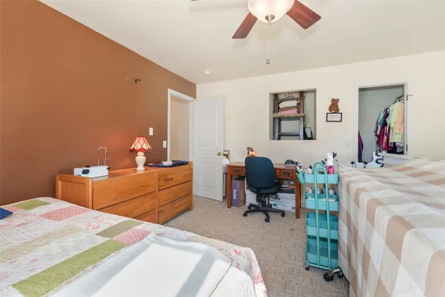 a bed room with a bed mirror and a desk