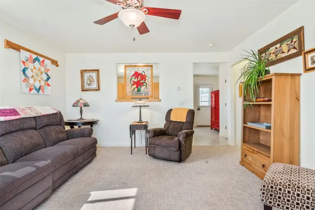 a living room with furniture and a open kitchen