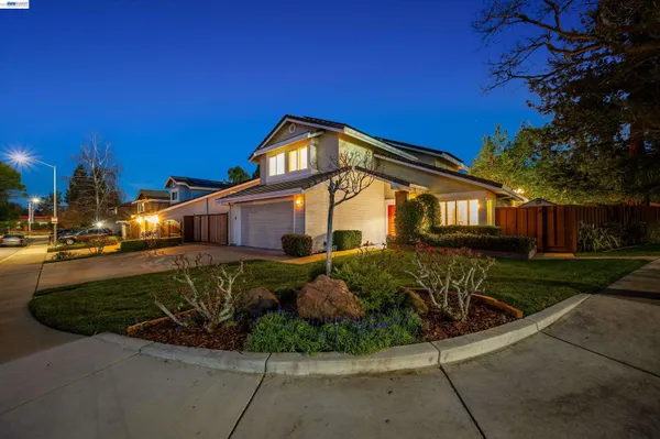 a view of a house with backyard and a patio