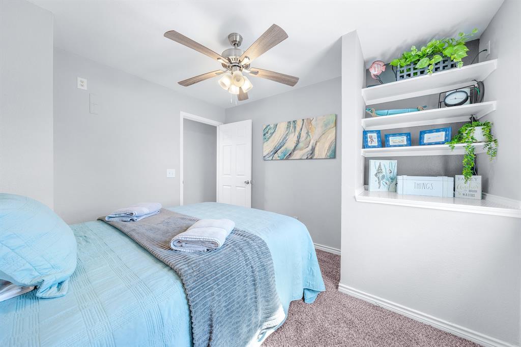 154 Wapiti Quitman, TX 75783 - Photo 16 of 24 a bedroom with a bed and a chandelier