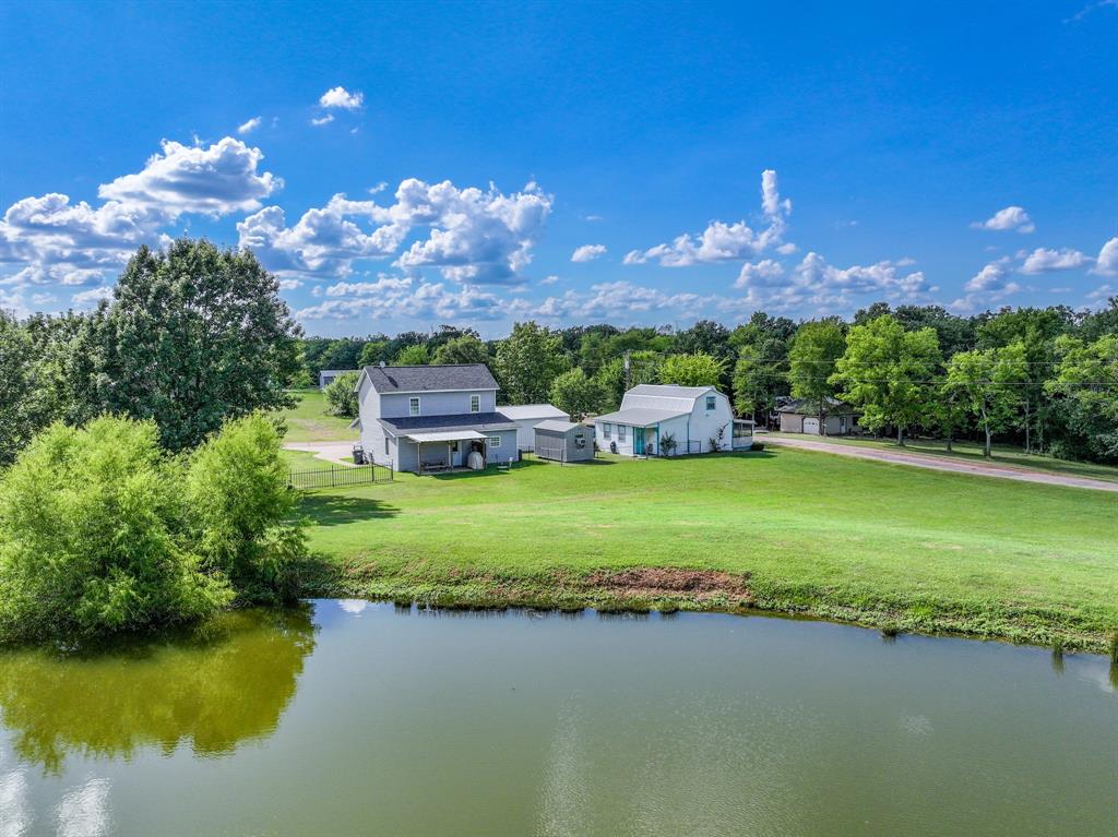 154 Wapiti Quitman, TX 75783 - Photo 23 of 24 a view of a lake with a building in the background