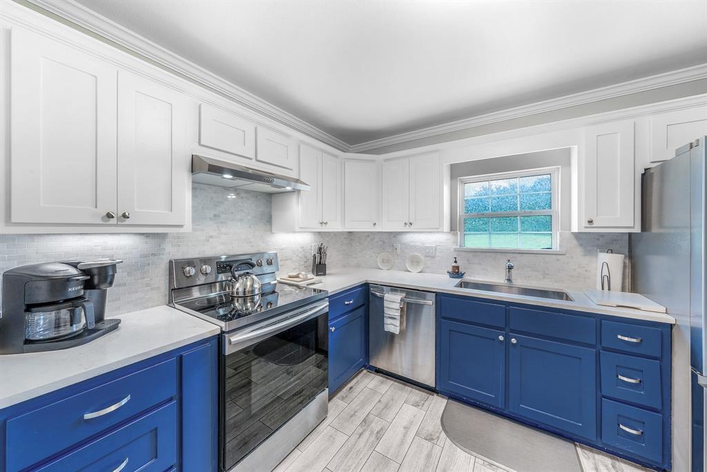 154 Wapiti Quitman, TX 75783 - Photo 9 of 24 a kitchen with stainless steel appliances granite countertop a sink stove and cabinets