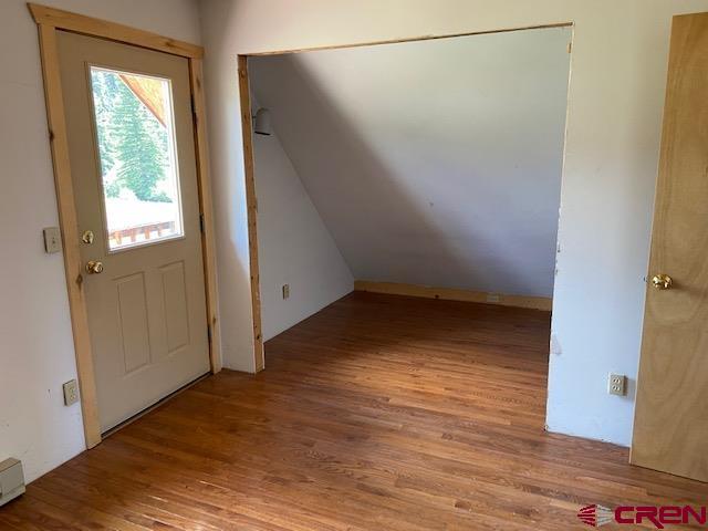 300 Quartz Lane Pitkin, CO 81241 - Photo 14 of 22 an empty room with wooden floor and windows