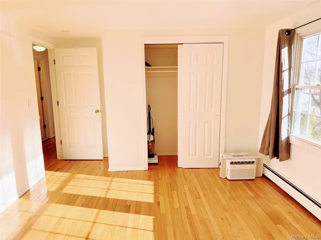 a view of a room with wooden floor and windows