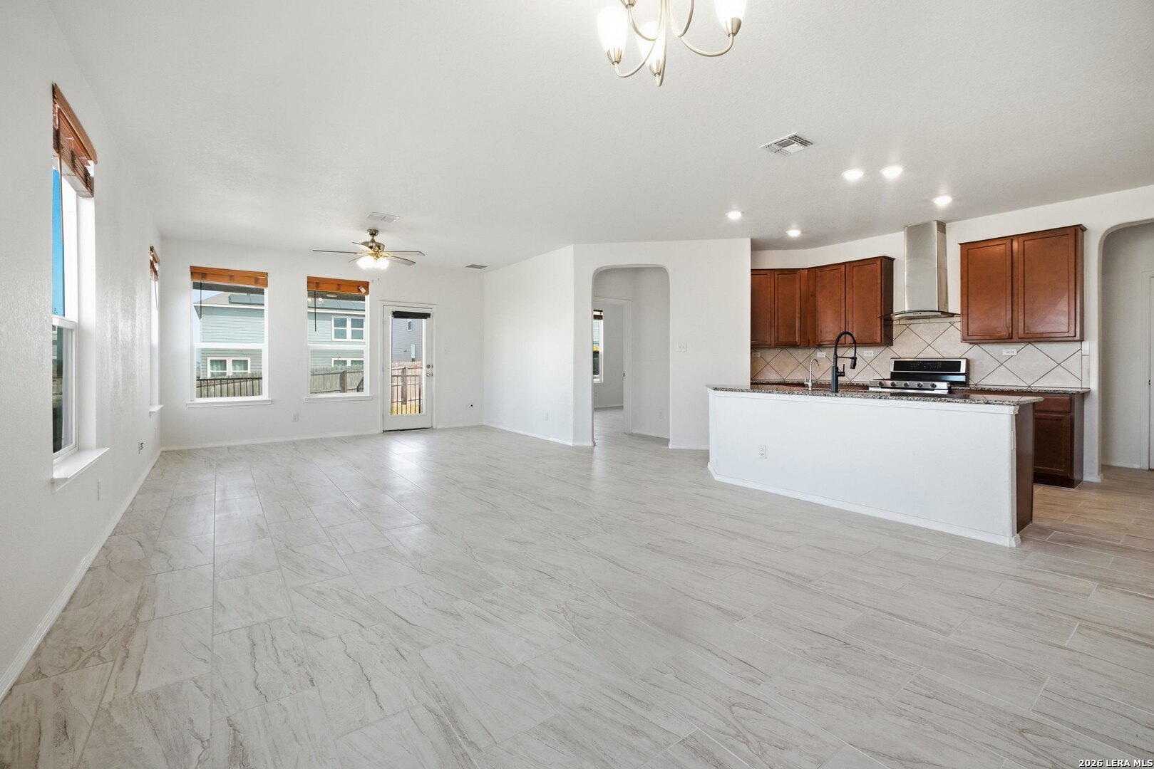 9305 Devils River Converse, TX 78109 - Photo 13 of 34 a view of kitchen with kitchen island a sink wooden floor and white stainless steel appliances