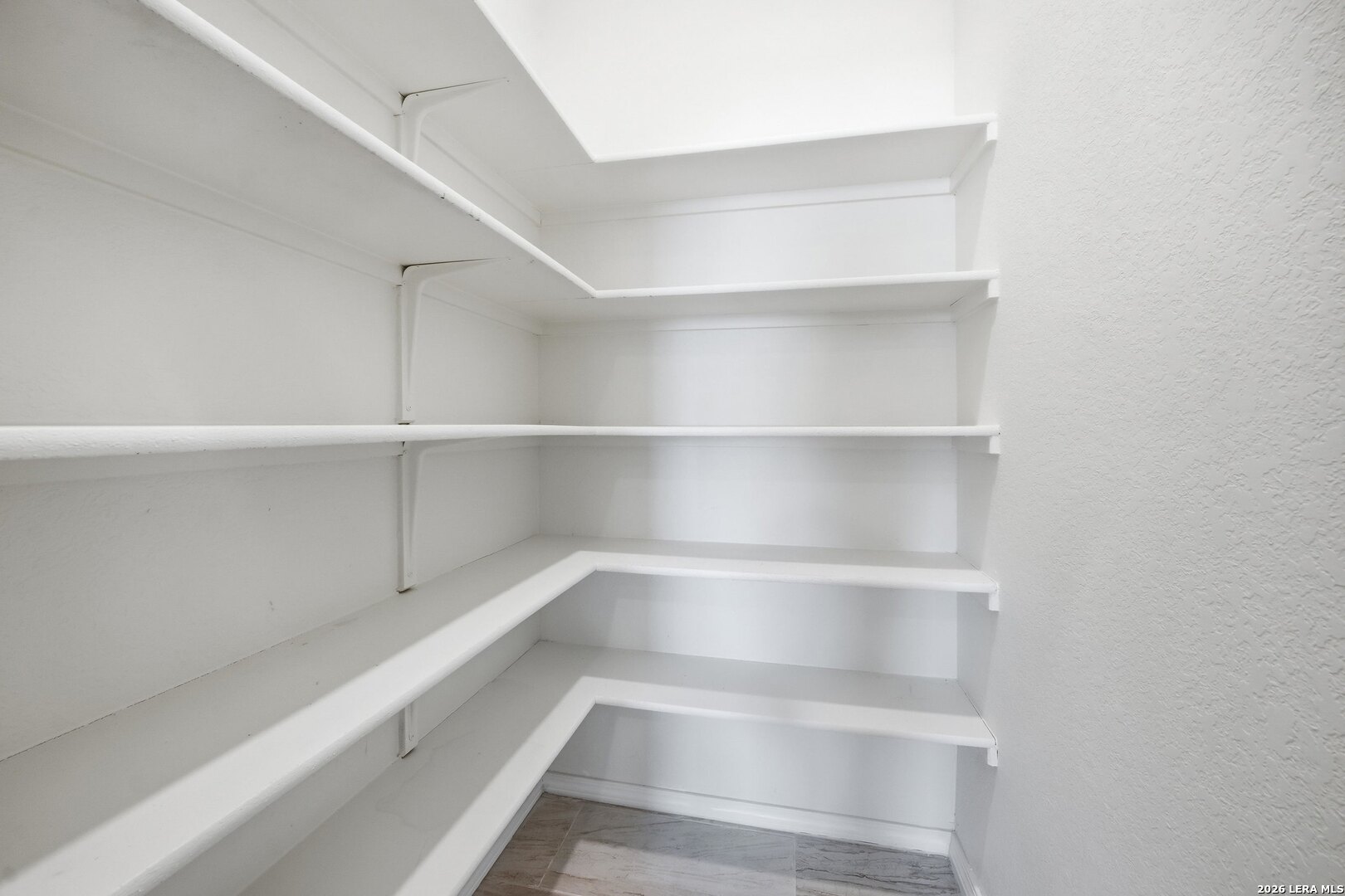 9305 Devils River Converse, TX 78109 - Photo 18 of 34 a view of walk in closet with empty racks