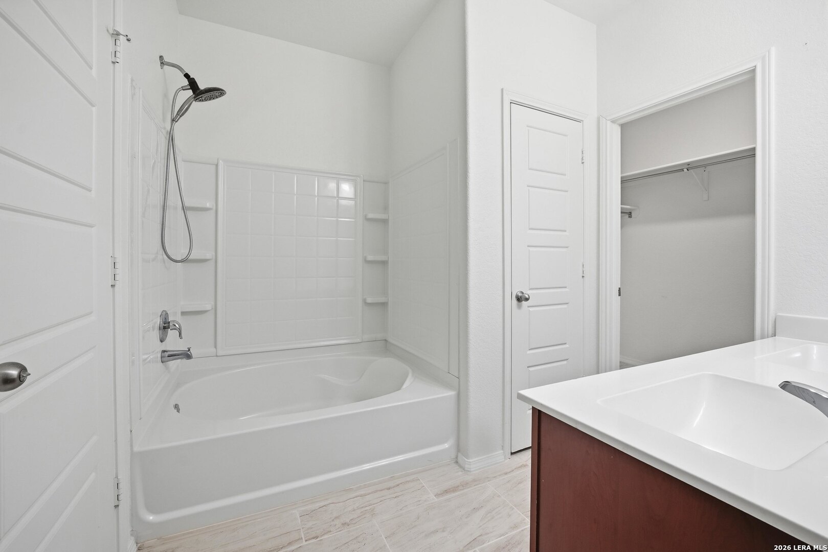 9305 Devils River Converse, TX 78109 - Photo 22 of 34 a bathroom with a bath tub sitting next to a white sink and vanity