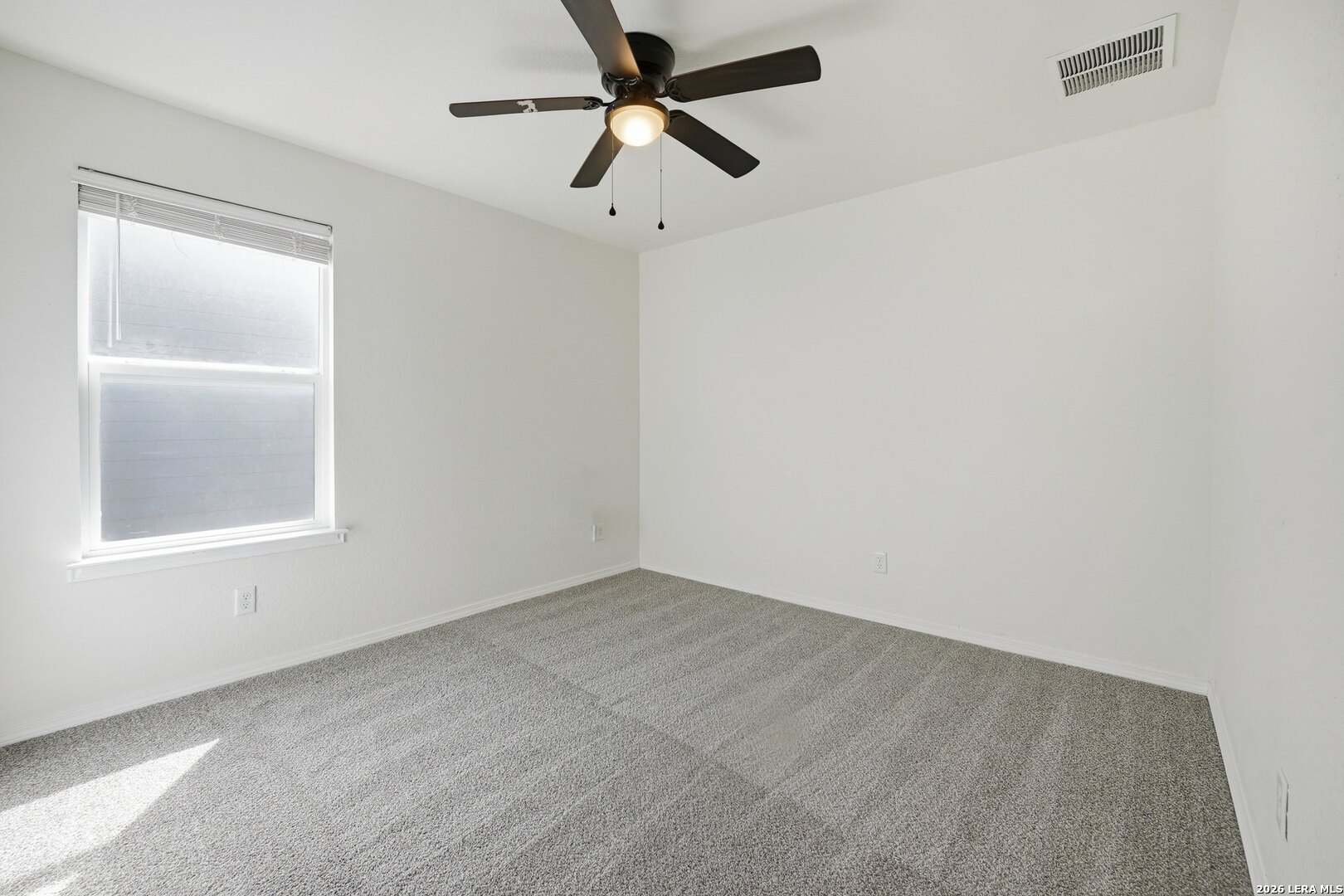 9305 Devils River Converse, TX 78109 - Photo 28 of 34 an empty room with a window and a fan