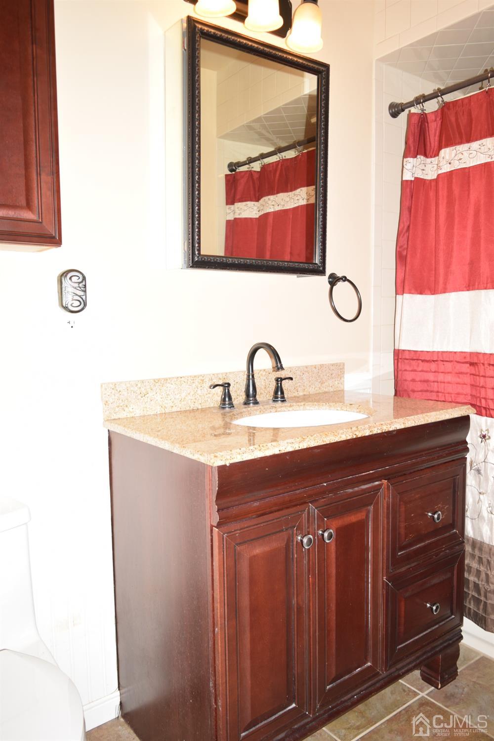 16 Parkerson Road Edison, NJ 08817 - Photo 11 of 11 a bathroom with a sink and a mirror