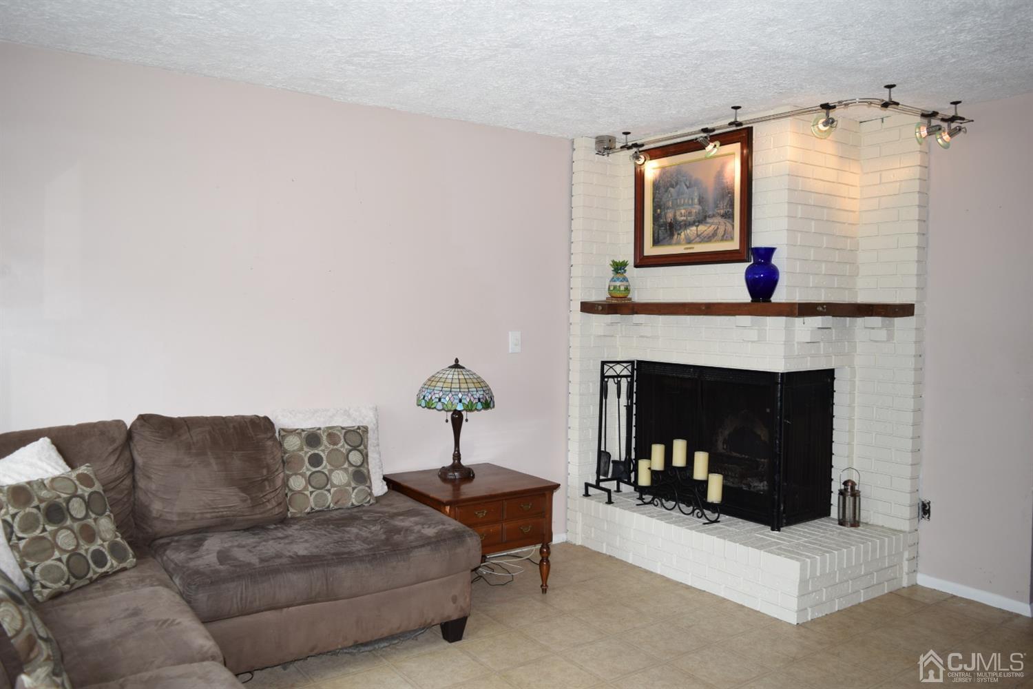 16 Parkerson Road Edison, NJ 08817 - Photo 5 of 11 a living room with furniture and a fireplace