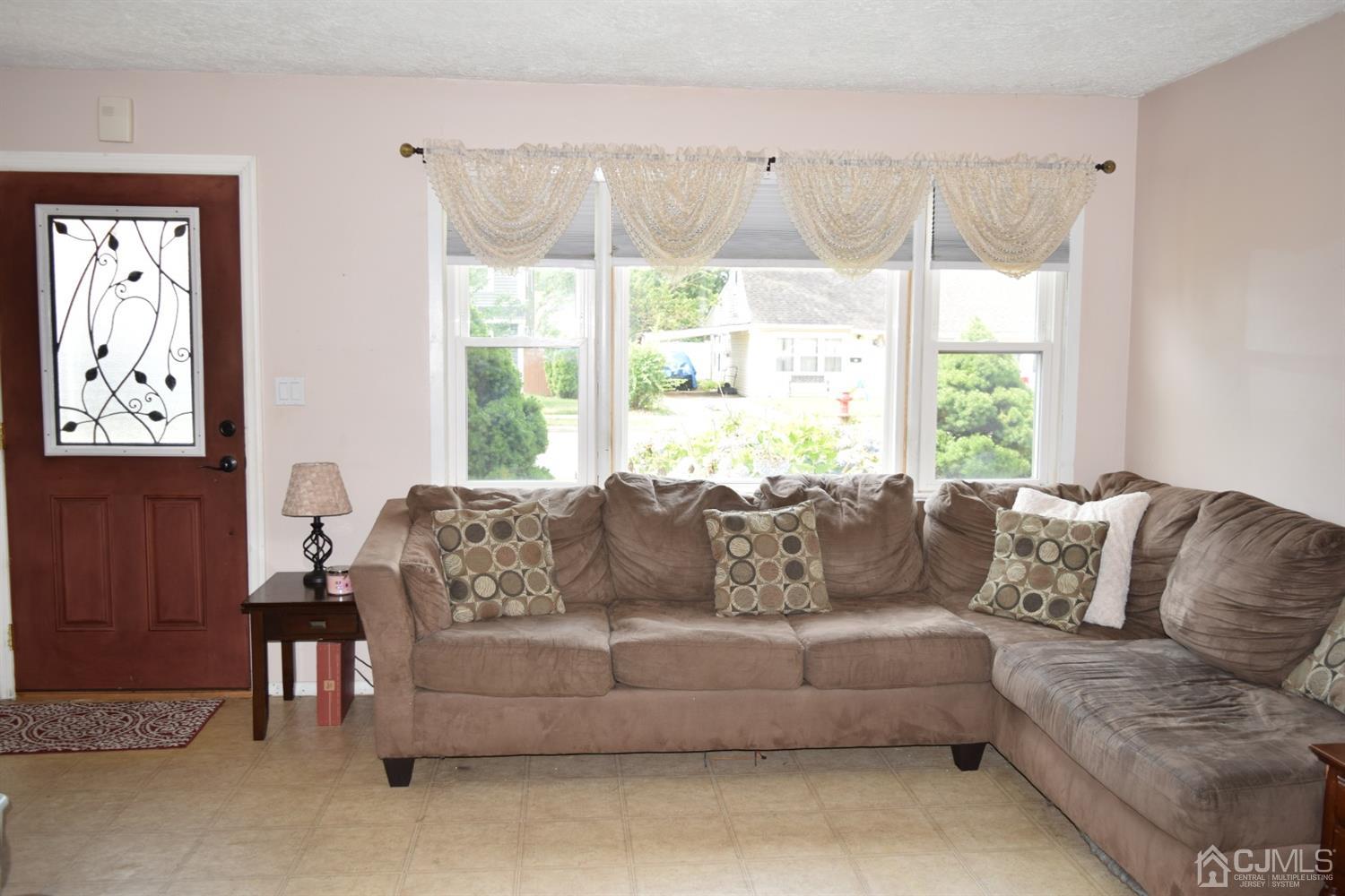 16 Parkerson Road Edison, NJ 08817 - Photo 6 of 11 a living room with furniture and a large window