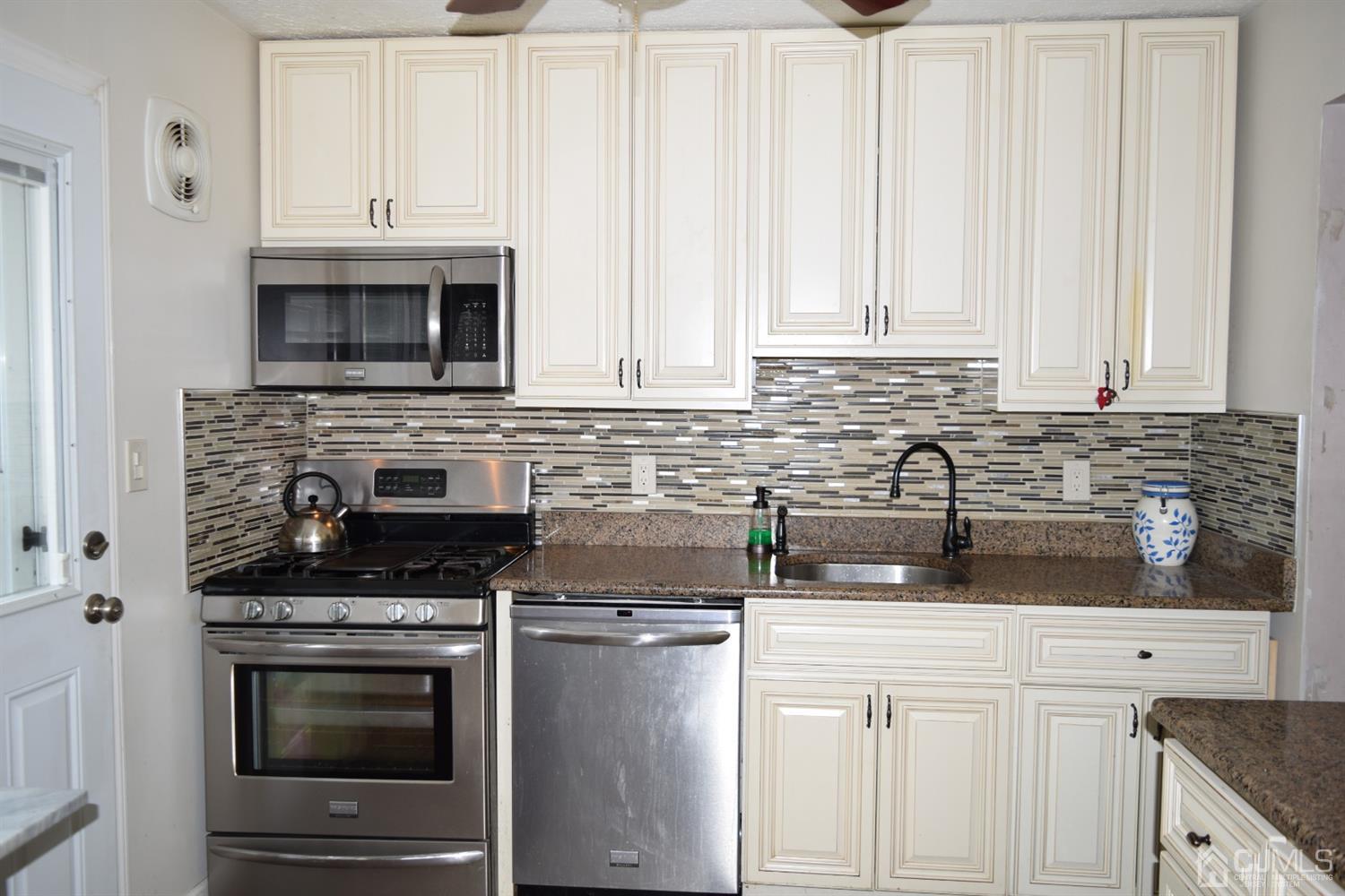 16 Parkerson Road Edison, NJ 08817 - Photo 8 of 11 a kitchen with granite countertop white cabinets and stainless steel appliances