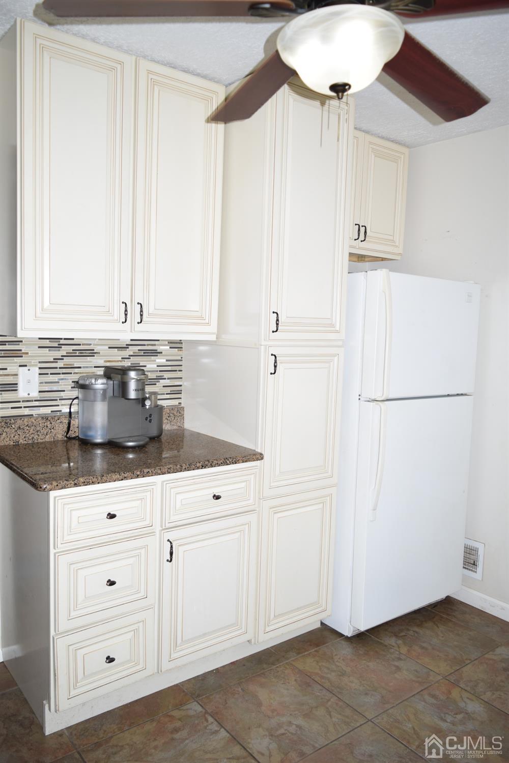 16 Parkerson Road Edison, NJ 08817 - Photo 9 of 11 a kitchen with granite countertop white cabinets and white appliances