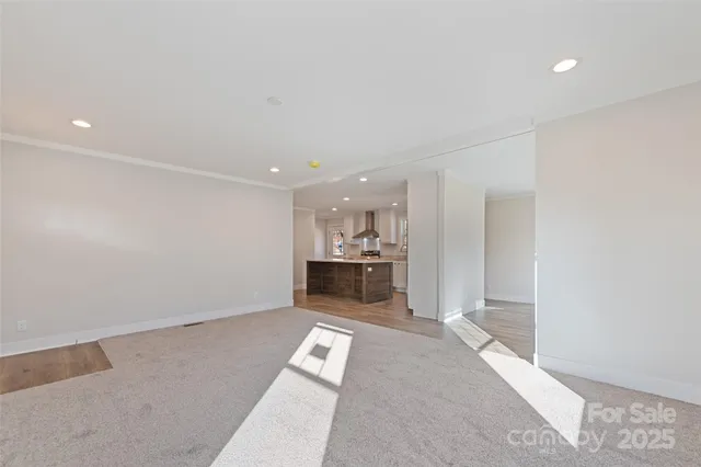 a view of a kitchen with a sink and dishwasher a refrigerator with white cabinets