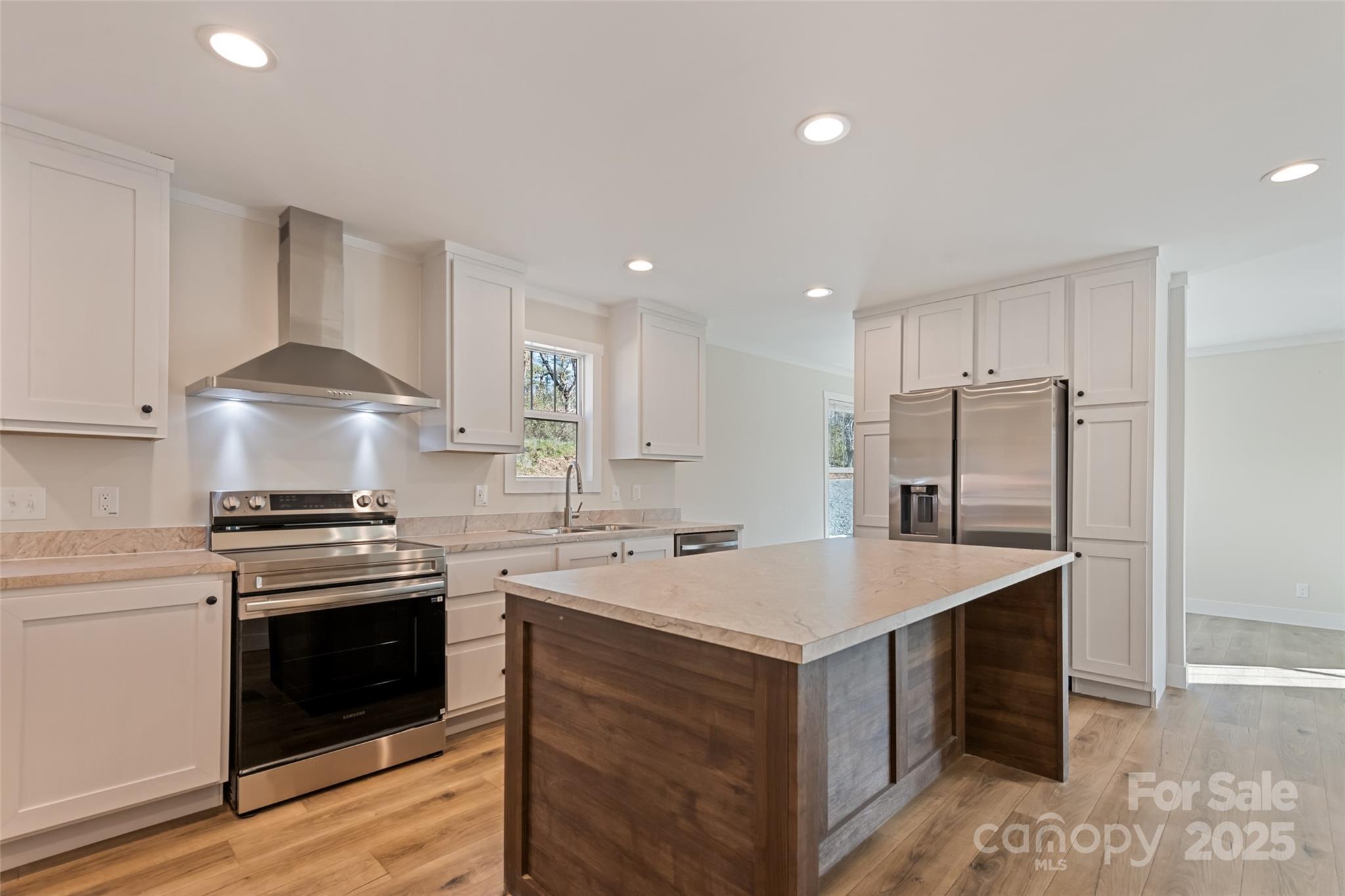 77 Geiranger Drive Clyde, NC 28721 - Photo 17 of 29 a kitchen with a stove a sink and a refrigerator