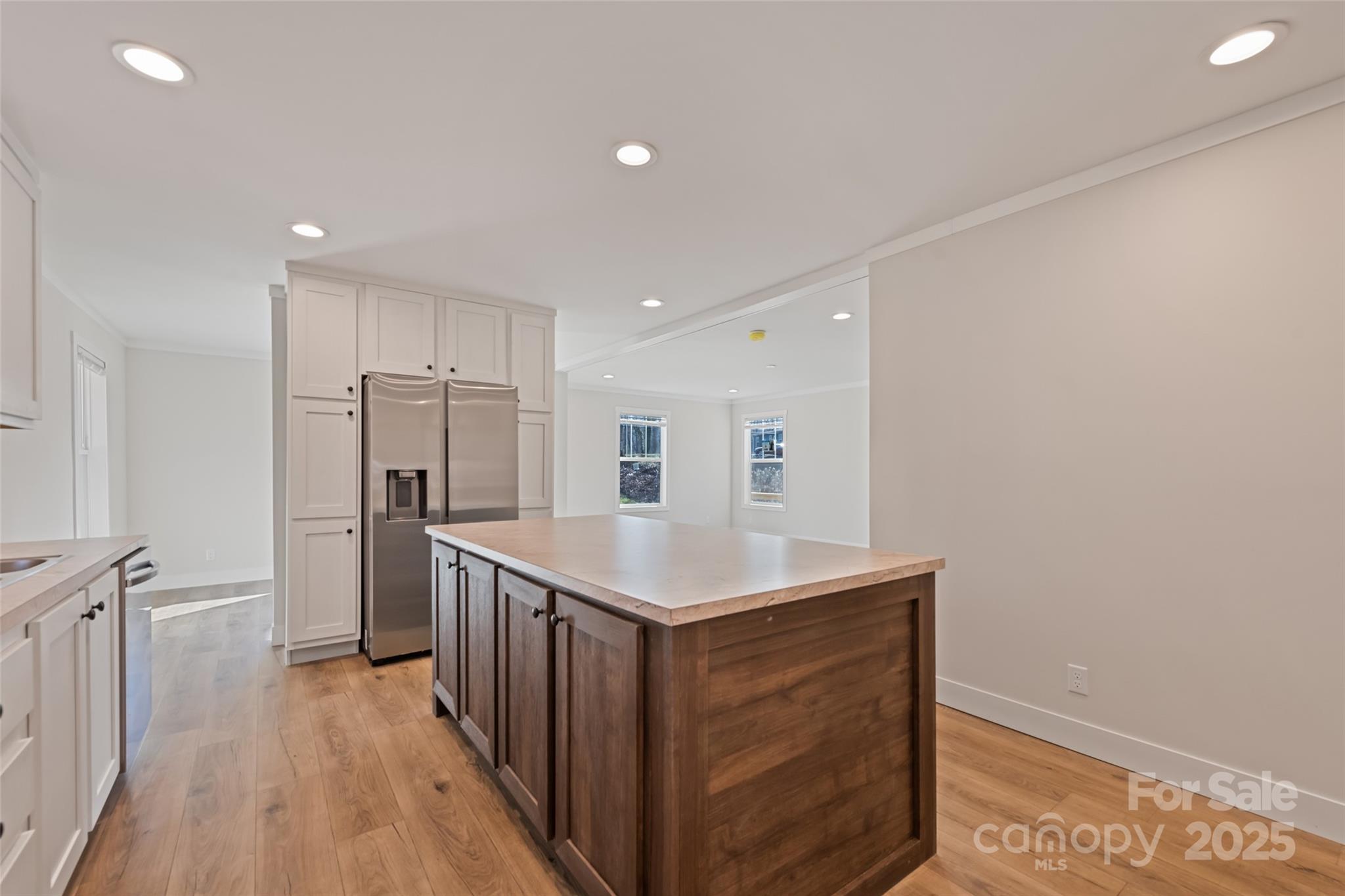 77 Geiranger Drive Clyde, NC 28721 - Photo 19 of 29 a kitchen with stainless steel appliances granite countertop a refrigerator a sink and wooden floor