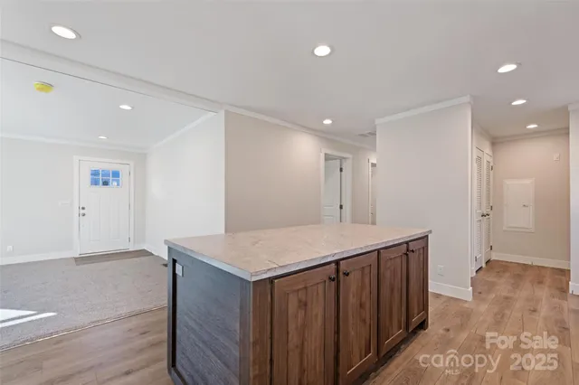 a kitchen with a wooden floor and cabinets