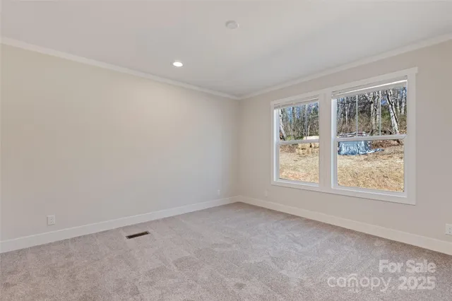 a view of an empty room and closet area