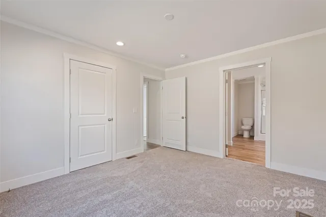 a spacious bathroom with a toilet sink and mirror