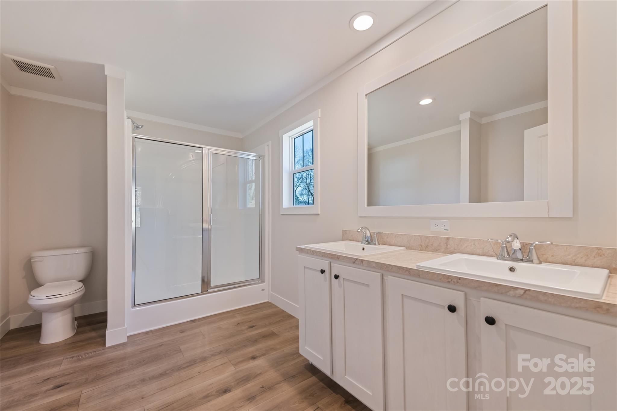 77 Geiranger Drive Clyde, NC 28721 - Photo 29 of 29 a spacious bathroom with a toilet sink and mirror