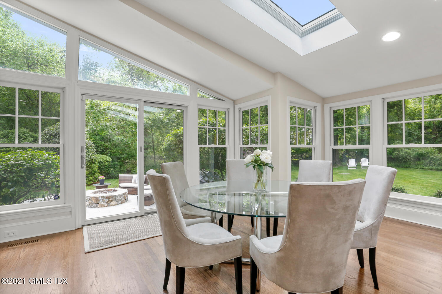 53 Hillcrest Park Road Old Greenwich, CT 06870 - Photo 18 of 53 a view of a dining room with furniture large windows and wooden floor