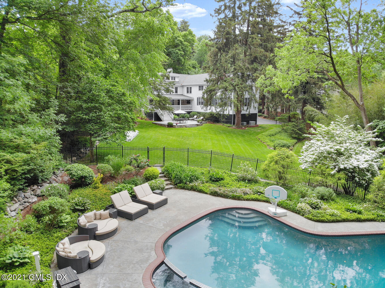 53 Hillcrest Park Road Old Greenwich, CT 06870 - Photo 2 of 53 a view of a swimming pool with a garden