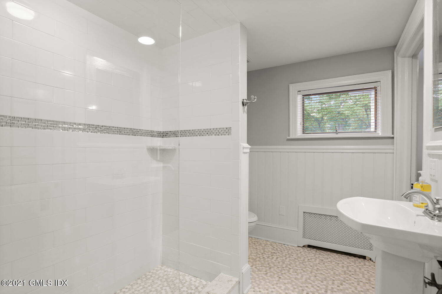 53 Hillcrest Park Road Old Greenwich, CT 06870 - Photo 33 of 53 a bathroom with a granite countertop sink a mirror and a shower