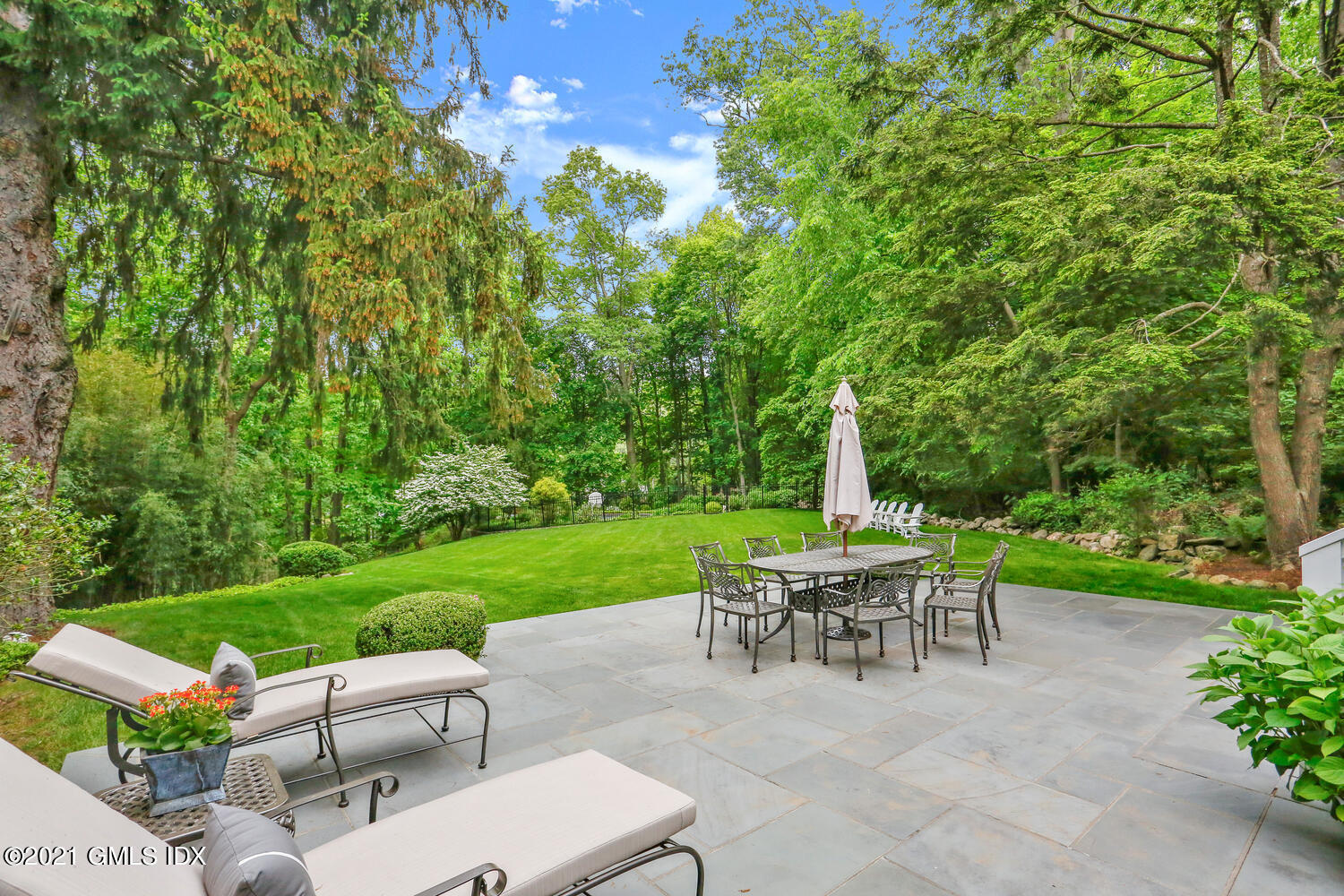 53 Hillcrest Park Road Old Greenwich, CT 06870 - Photo 44 of 53 a view of a chair and table in backyard of the house