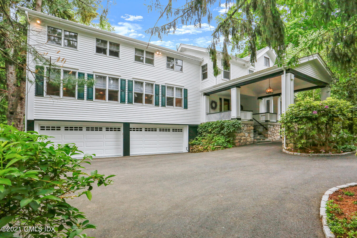 53 Hillcrest Park Road Old Greenwich, CT 06870 - Photo 49 of 53 front view of a house with a garden
