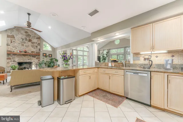 a kitchen with stainless steel appliances granite countertop a stove and white cabinets