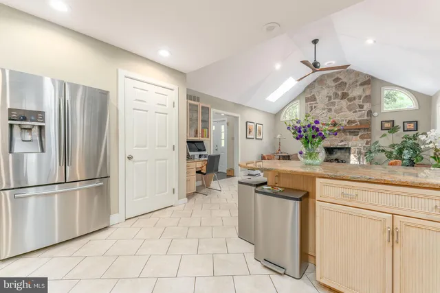 a kitchen with stainless steel appliances granite countertop a refrigerator and a sink