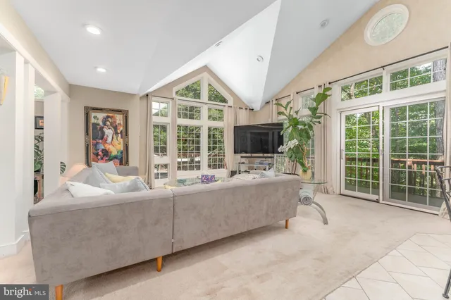 a living room with furniture tv and large window