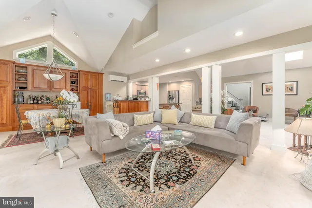 a living room with furniture and a dining table