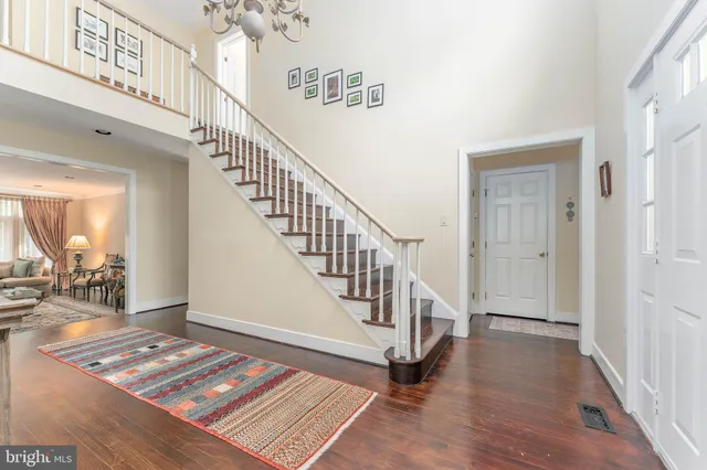 a view of entryway and hall with wooden floor