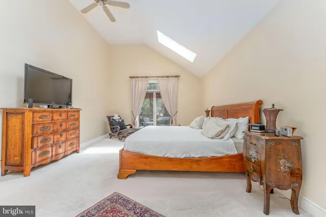 a bedroom with a bed and a television