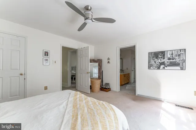 a spacious bedroom with a bed and a large window