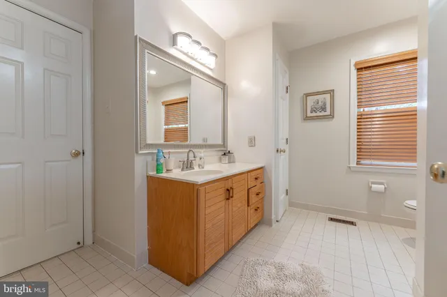 a spacious bedroom with a bed and a desk