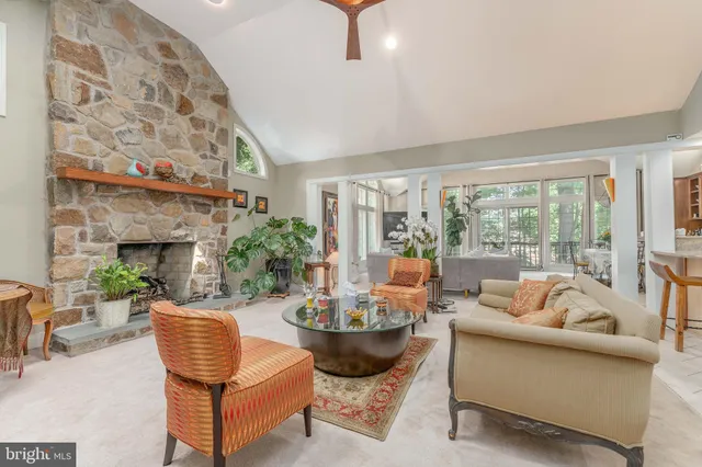 a living room with fireplace furniture and a large window