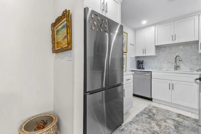 a kitchen with a refrigerator and cabinets