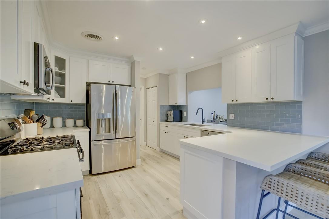 4117 McKinley Street Hollywood, FL 33021 - Photo 12 of 52 a kitchen with refrigerator a stove and a refrigerator