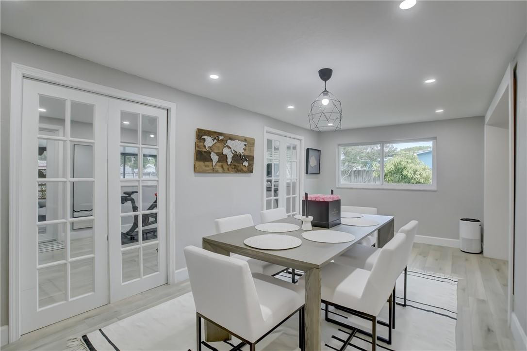 4117 McKinley Street Hollywood, FL 33021 - Photo 22 of 52 a dining room with furniture a window and wooden floor
