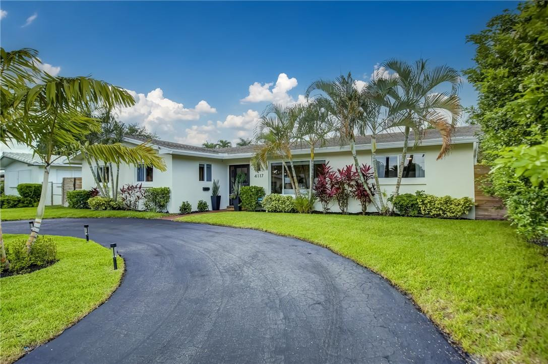 4117 McKinley Street Hollywood, FL 33021 - Photo 3 of 52 a view of a house with a yard and potted plants