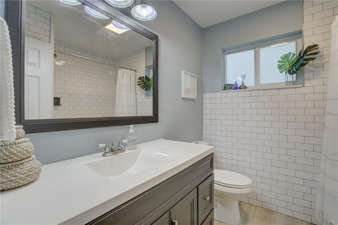 4117 McKinley Street Hollywood, FL 33021 - Photo 39 of 52 a bathroom with a sink a toilet and mirror