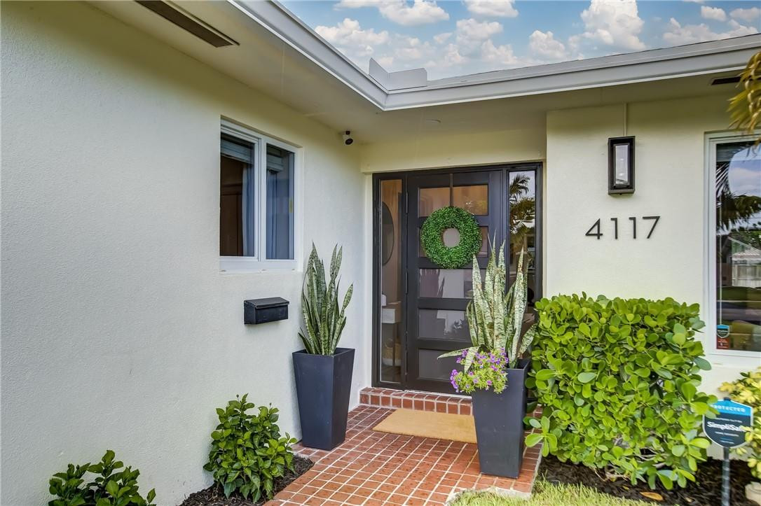 4117 McKinley Street Hollywood, FL 33021 - Photo 4 of 52 a front view of a house with a yard