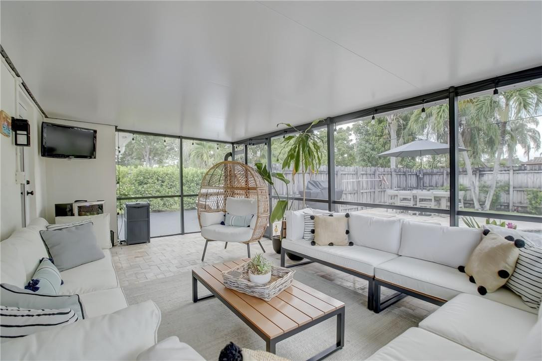4117 McKinley Street Hollywood, FL 33021 - Photo 45 of 52 a living room with furniture large windows and a flat screen tv