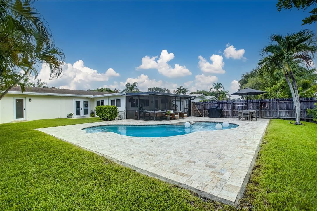 4117 McKinley Street Hollywood, FL 33021 - Photo 48 of 52 a view of a house with swimming pool and a yard